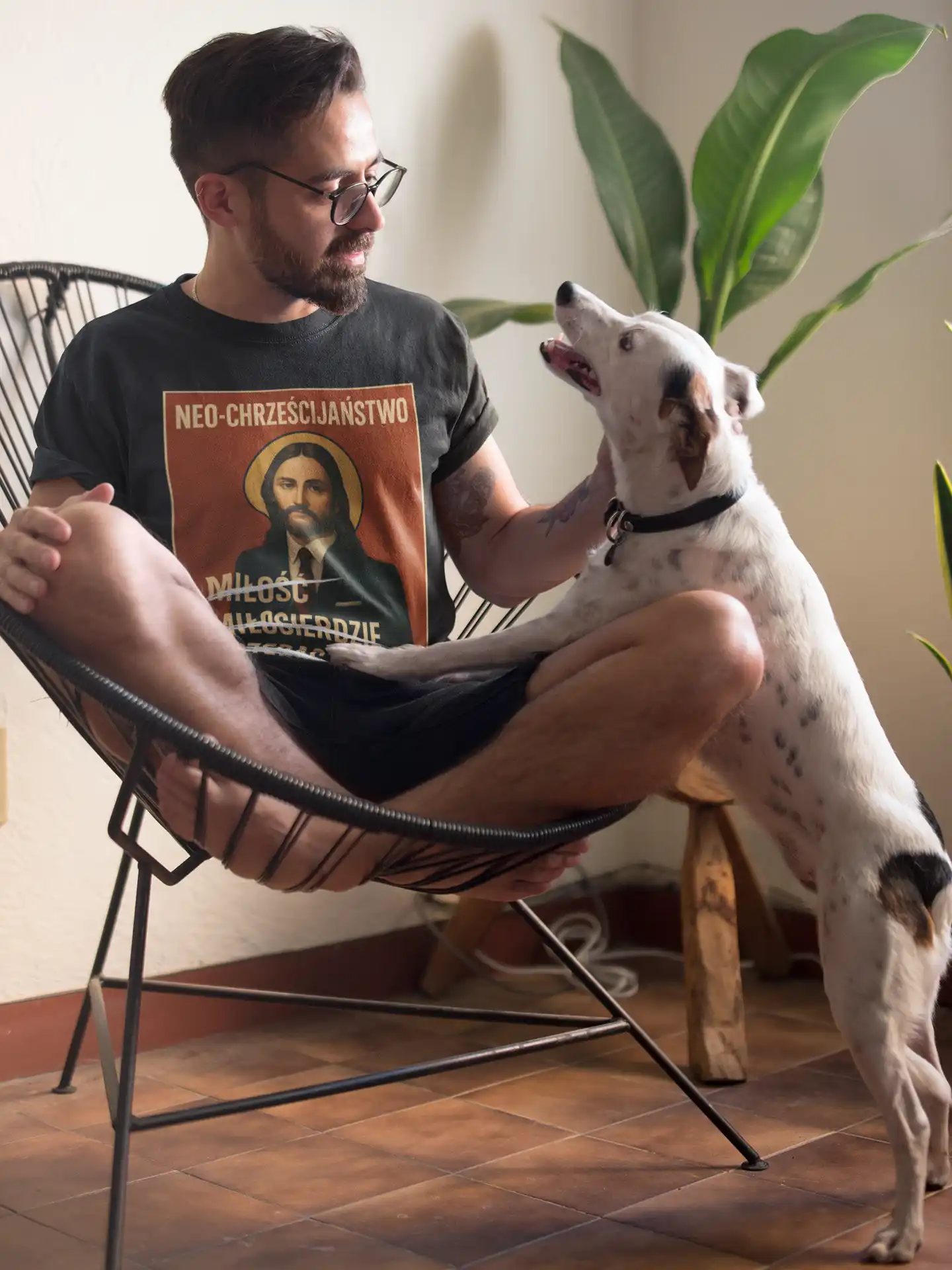 tee-mockup-of-a-man-sitting-on-an-acapulco-chair-petting-his-dog-18085 (15)