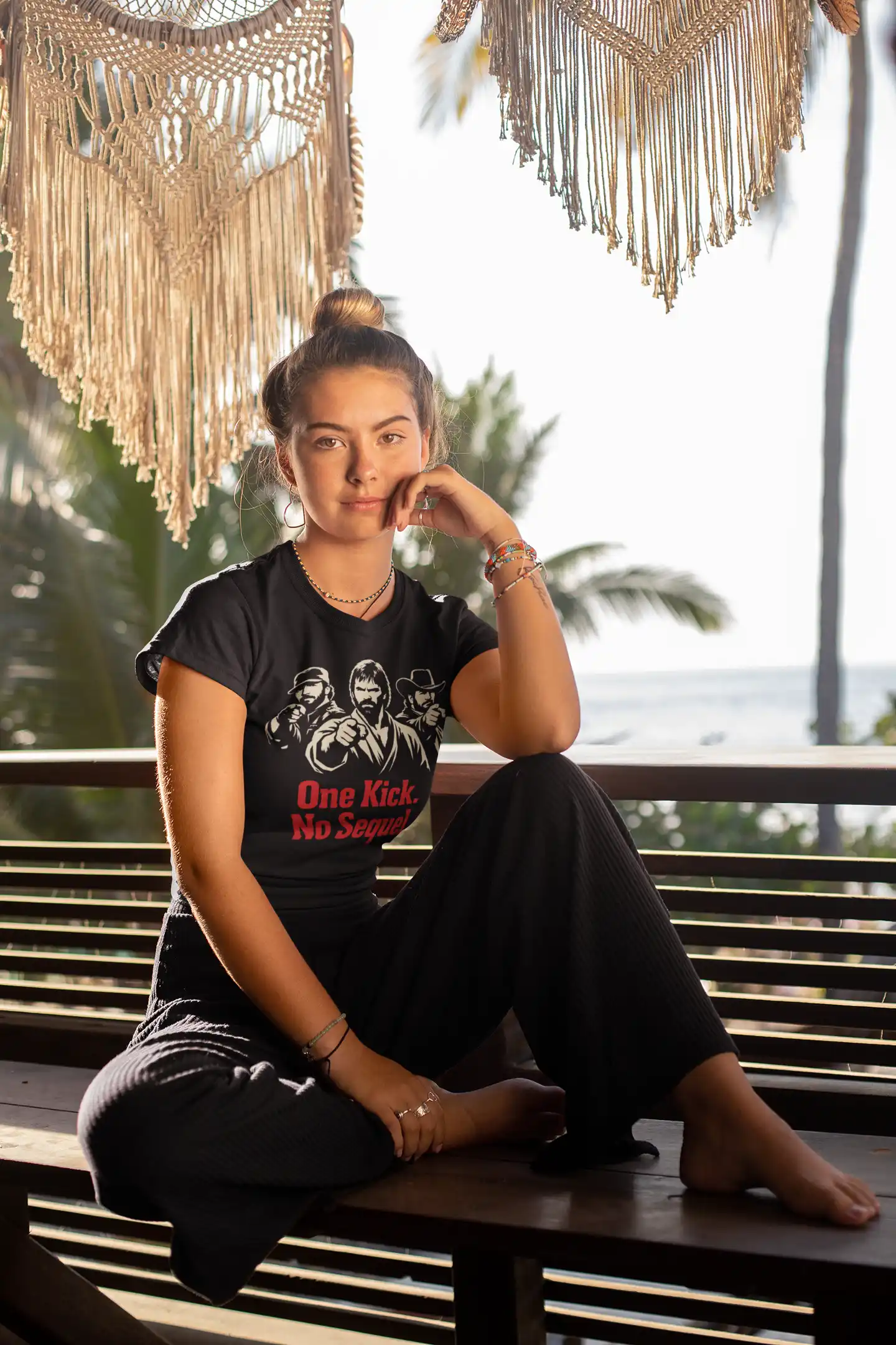tee-mockup-of-a-woman-with-a-hair-bun-sitting-on-a-bench-by-the-beach-26863 (2)